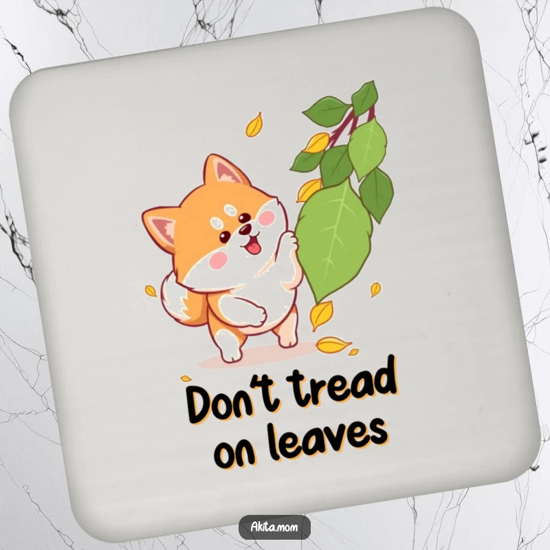 Funny Kawaii Akita drink coaster featuring a playful dog with alert ears pouncing on a falling autumn leaf, adding a cute touch to any table.