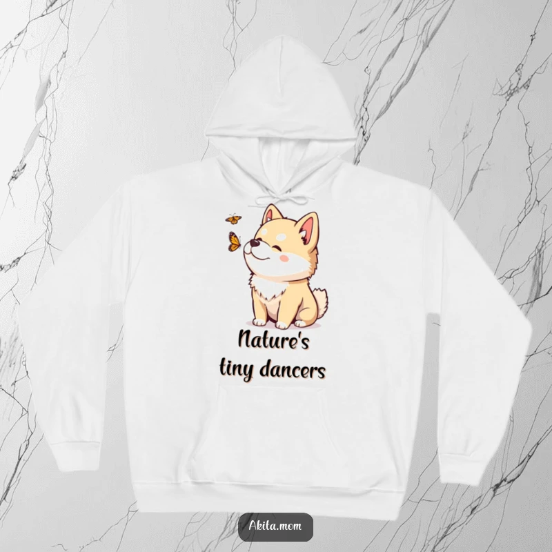 Funny Kawaii Akita hoodie with a playful head tilt, observing a fluttering butterfly, exuding peaceful curiosity and charm.