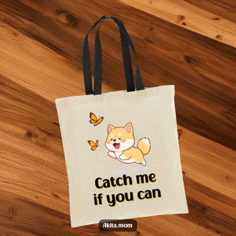 Funny Akita cub tote bag with a cute puppy chasing a butterfly, offering a humorous and practical accessory for dog fans.